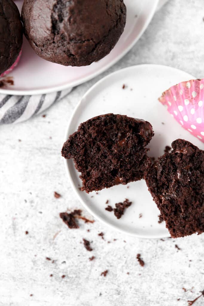 chocolate espresso muffin cut open on a white round plate