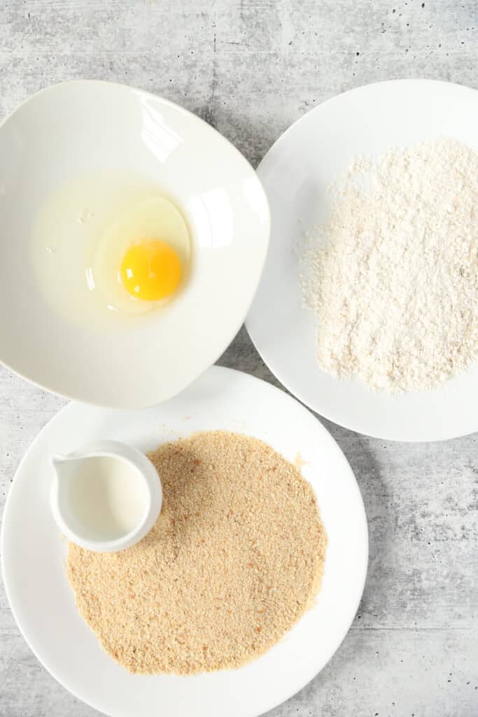 overhead shot of the egg, flour, breadcrumbs, and cream.