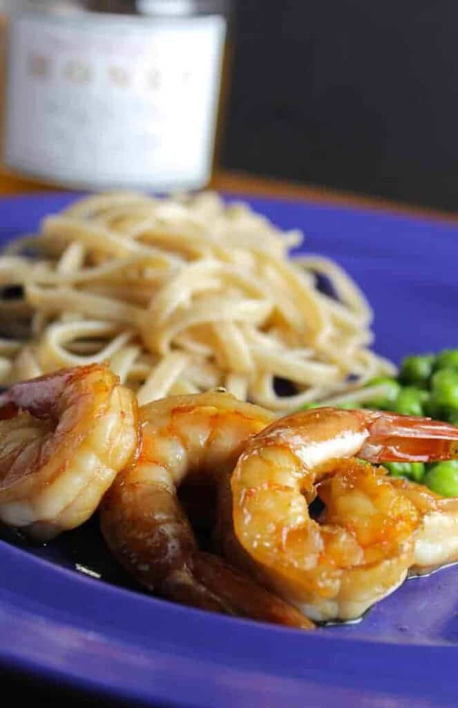 sauteed shrimp on a blue plate.