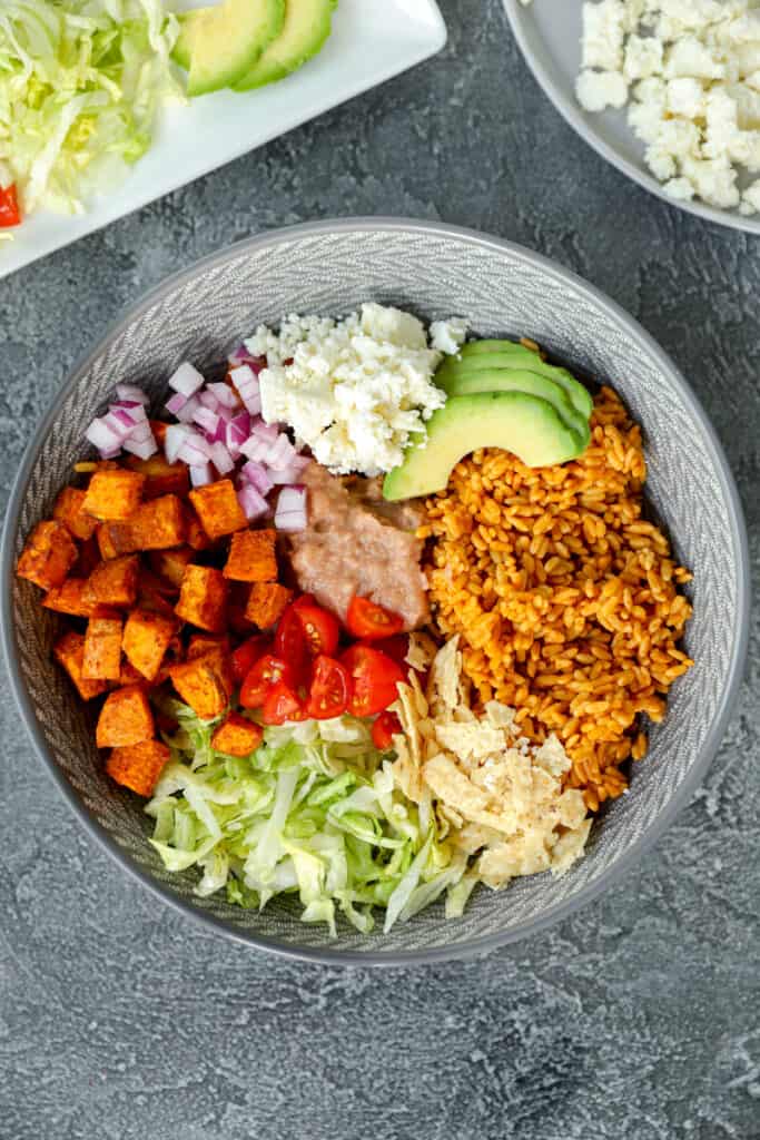 overhead shot of the sweet potato taco bowl on a dark grey surface