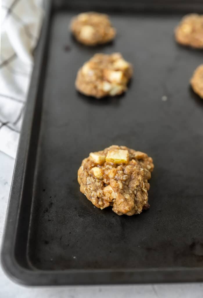 the baked cookies on the dark nonstick baking sheet.