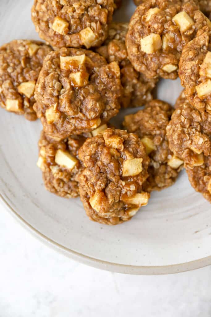 overhead shot of apple pie cookies on a grey plate.