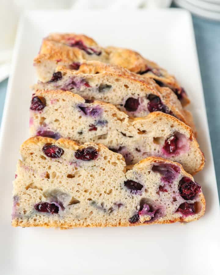 slices of the blueberry soda bread on a rectangle white plate.