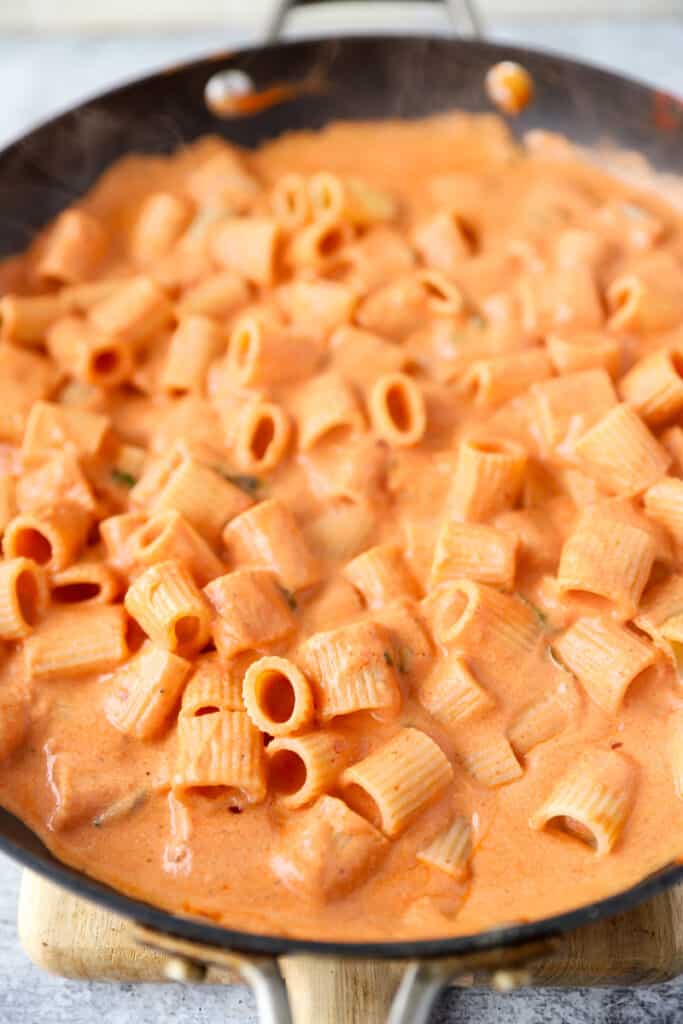 spicy vodka sauce with rigatoni pasta in a black nonstick pan.