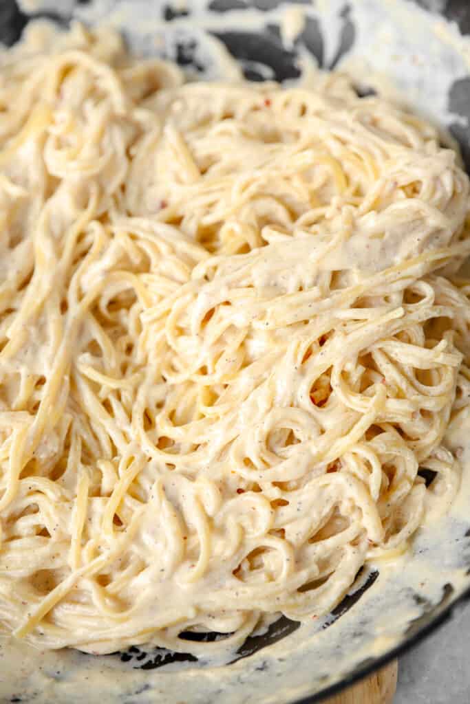 the thin linguini in the spicy Alfredo sauce in the nonstick pan.