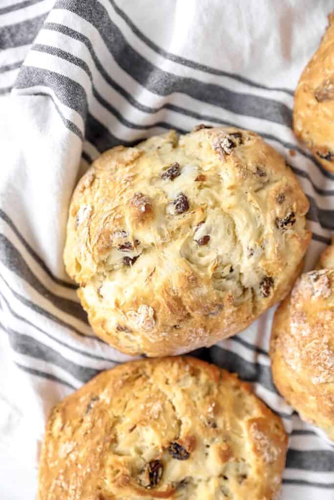 overhead photo of the Irish soda bread loaf on a striped linen napkin.