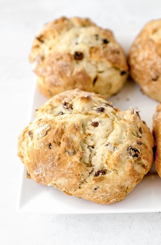 a mini loaf of Irish soda bread on a white plate.