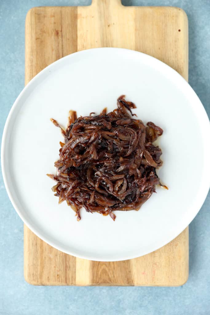 overhead photo of the caramelized red onions on a white plate.