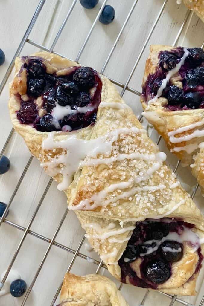blueberry Danishes on a wire baking rack.