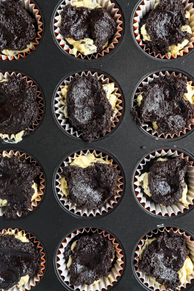 overhead photo of the completed layered muffins with the chocolate batter on top before baking.