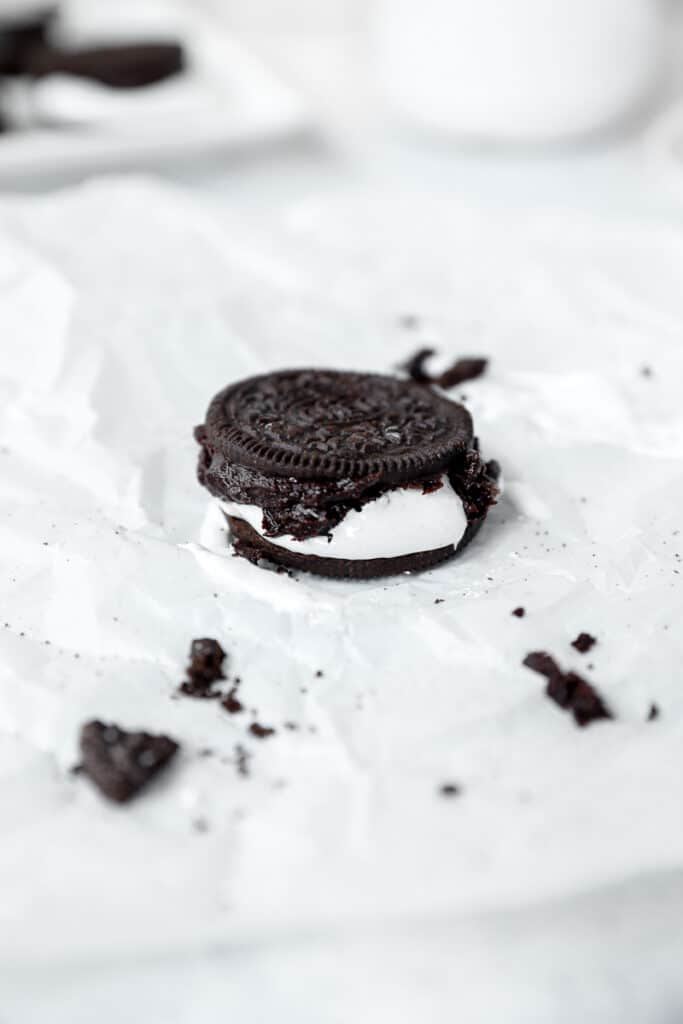 one oreo s'more on parchment paper with oreo crumbles scattered about.