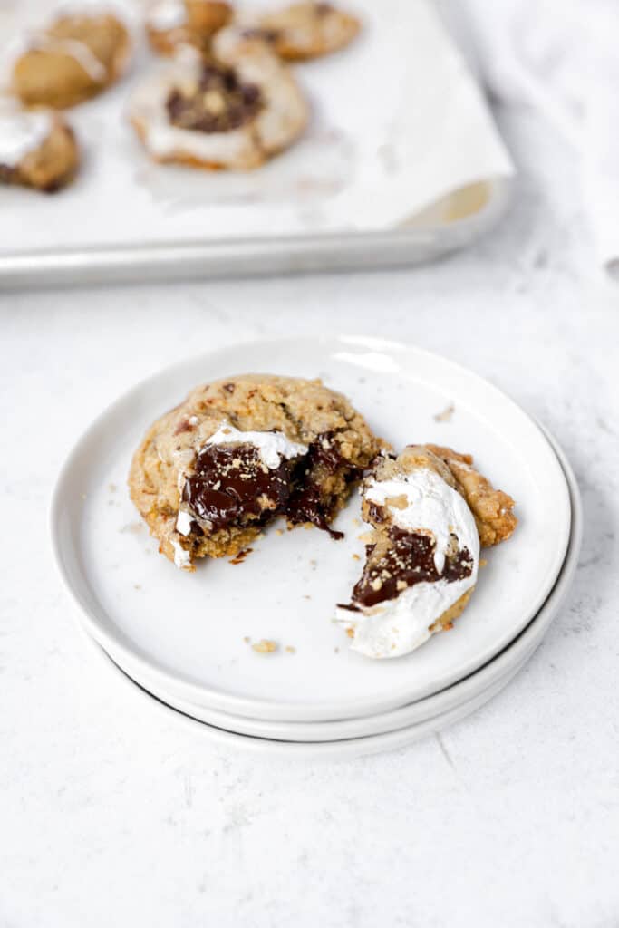 s'mores cookie on a stack of white round plates.