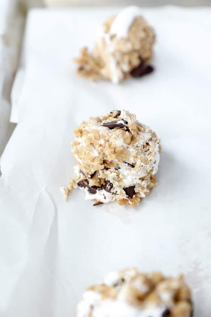 unbaked cookie dough on the parchment paper lined baking sheet.