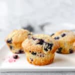 Jordan Marsh blueberry muffins on a white square plate.