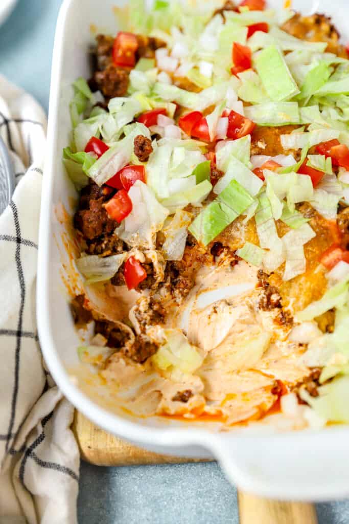 hot taco dip in a white casserole dish