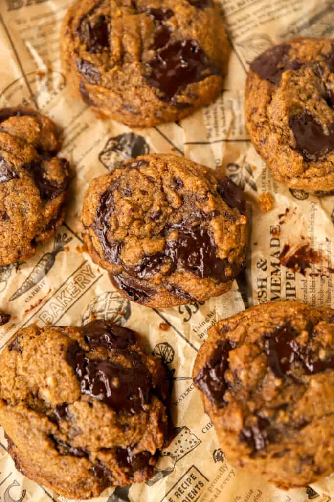 collection of the pumpkin chocolate chunk cookies on brown newsprint paper.