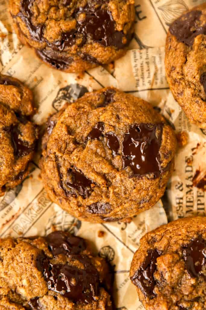 close photo of the pumpkin chocolate chunk cookies on brown newsprint paper.