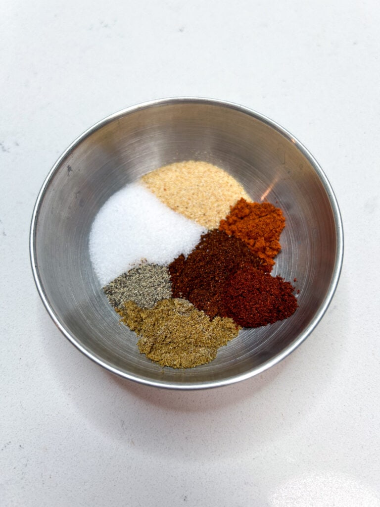 the spice blend in a small silver bowl.