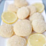 a white rectangle tray of lemon cookies with lemon slices.