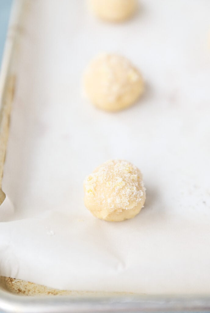 the unbaked cookie dough calls on a parchment paper lined baking sheet.