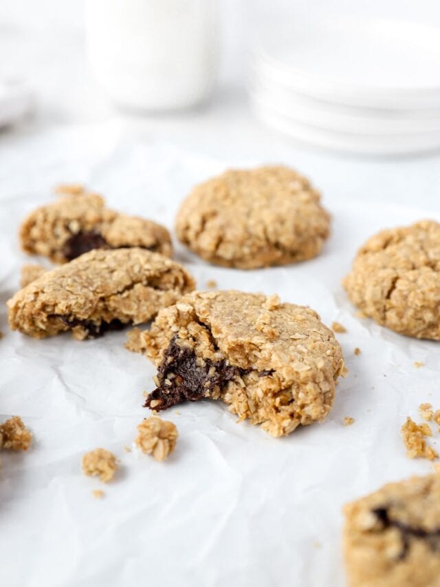 chocolate stuffed oatmeal cookies on parchment paper