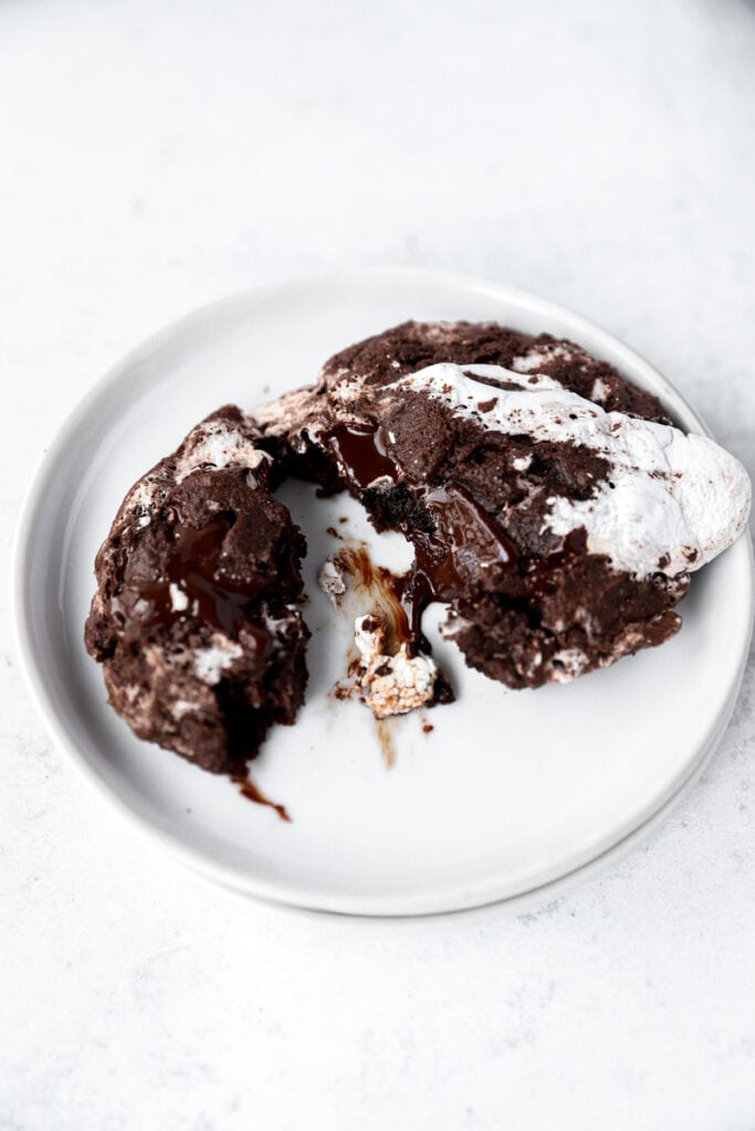one hot cocoa cookie on round white plates.