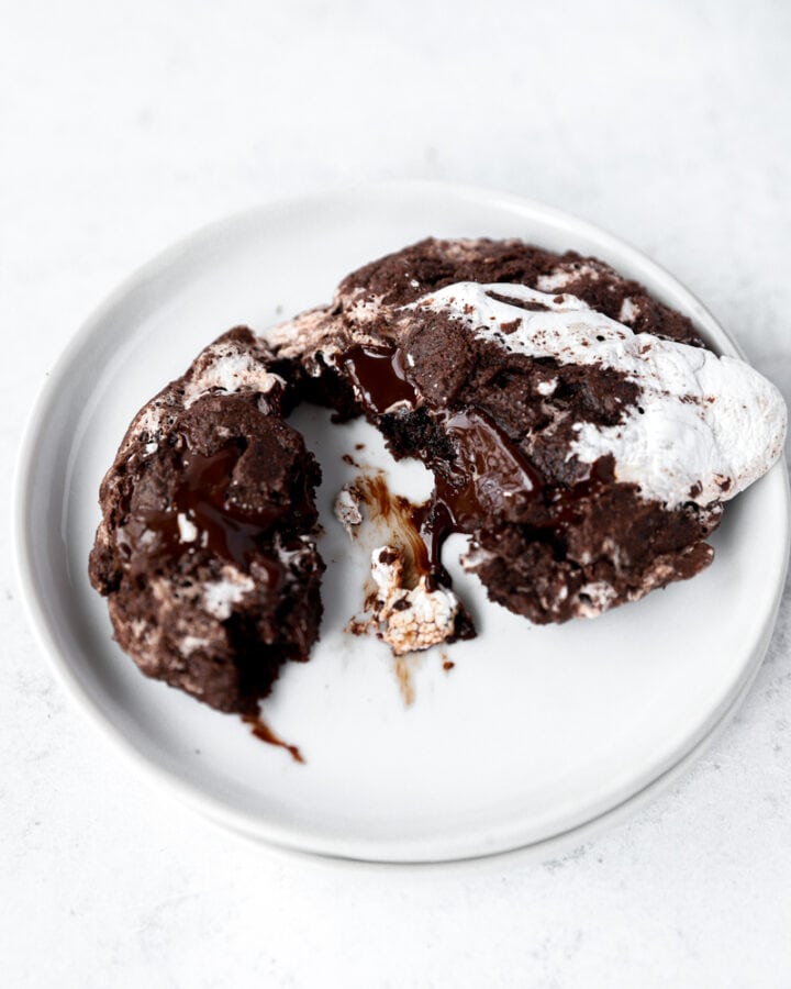 one hot cocoa cookie on round white plates.