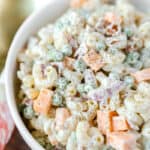 loaded pasta salad in a white bowl