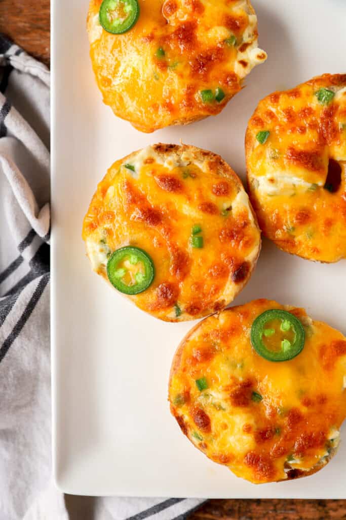 overhead photo of Jalapeño popper bagels on a white platter.