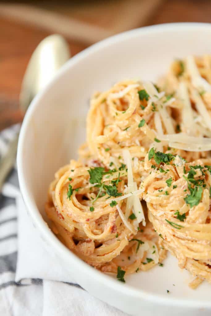 spirals of the marry me pasta topped with parsley in a large white bowl.