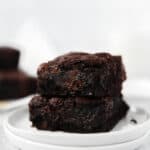 stack of 2 espresso brownies on a round white plate.