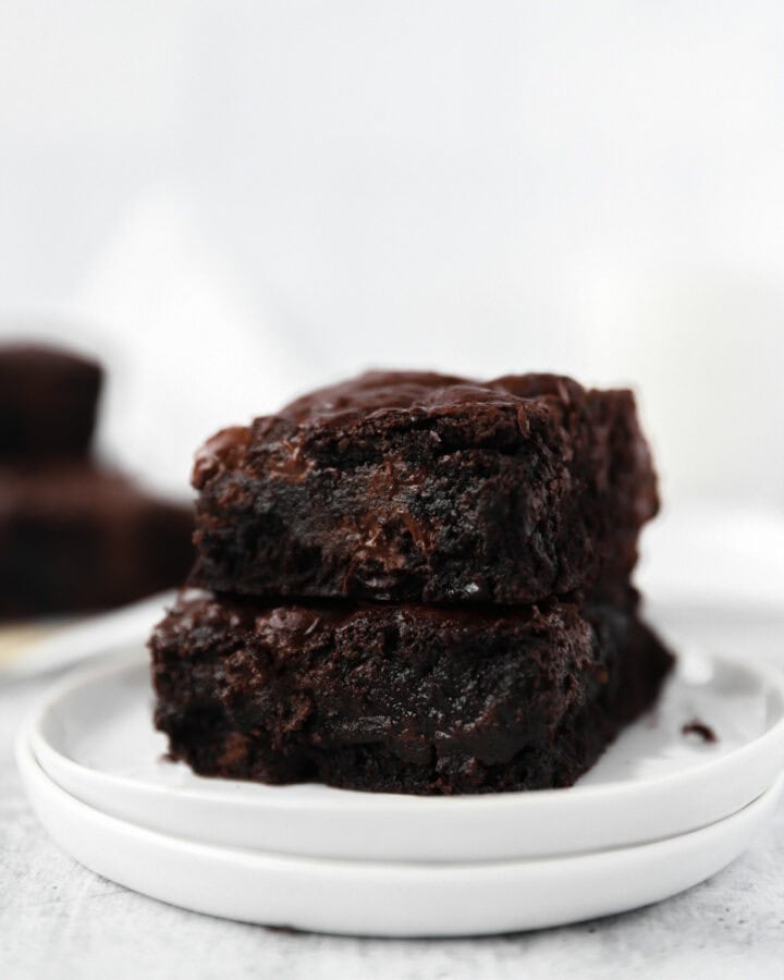 stack of 2 espresso brownies on a round white plate.
