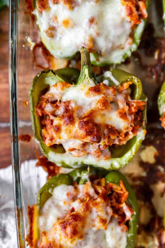 overhead photo of a baked Italian stuffed pepper in a clear casserole dish.
