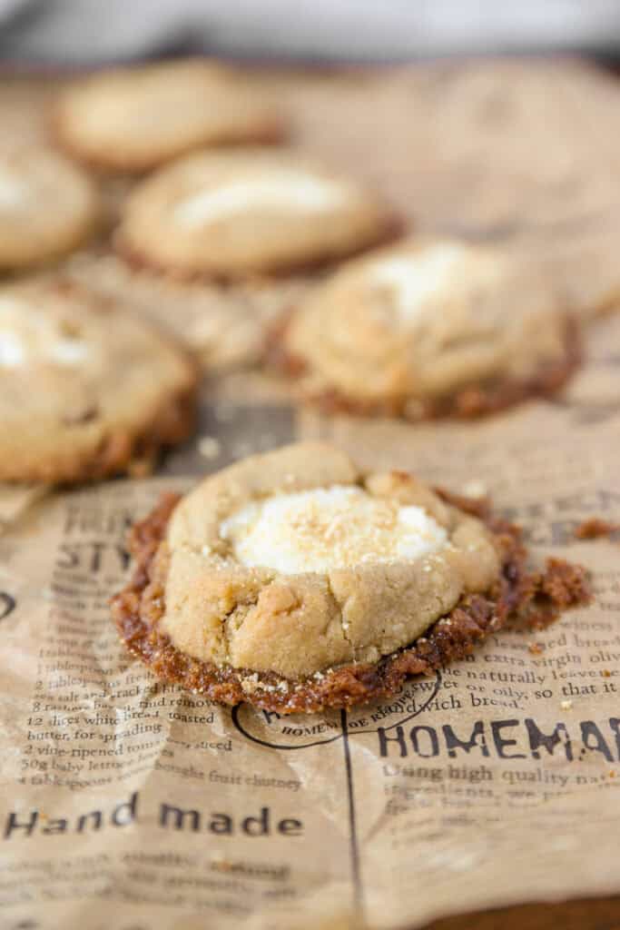 close photo of a cheesecake cookie on brown newsprint paper.