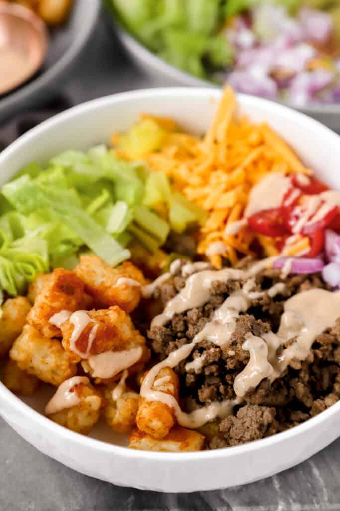 burger bowls in a white bowl topped with the special burger sauce.