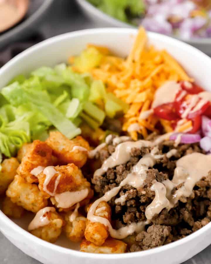 burger bowls in a white bowl topped with the special burger sauce.