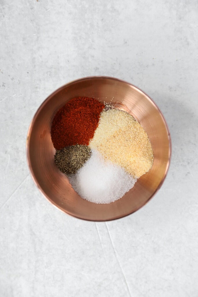 side by side two photos. Left photo shows the burger sauce in a stainless steel bowl. Right photo shows the seasonings in a copper dish.