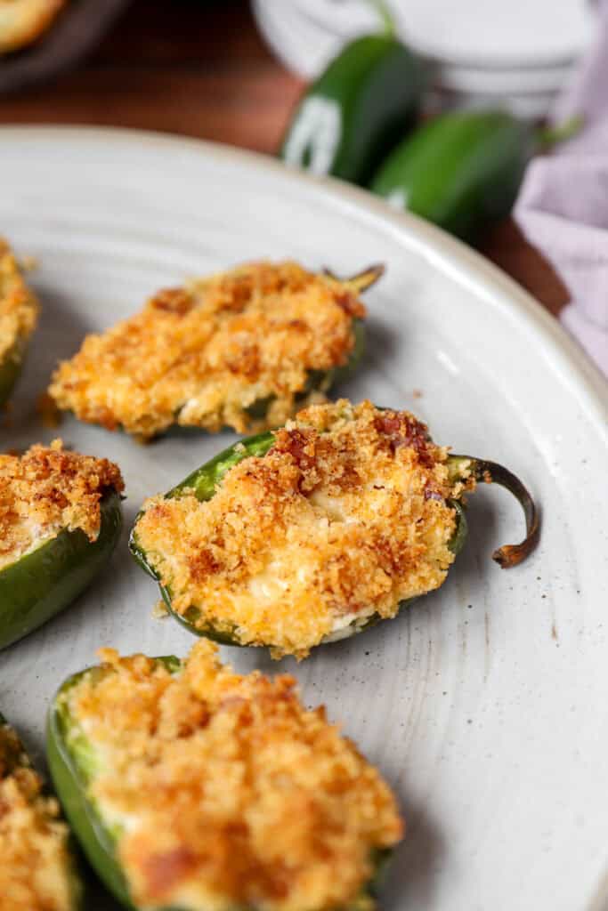 Several of the baked Jalapeño Poppers on a grey round plate