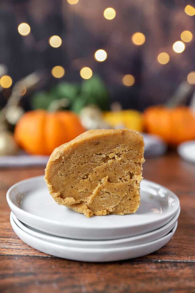 a slice of the chilled dough on a stack of 3 white round plates.