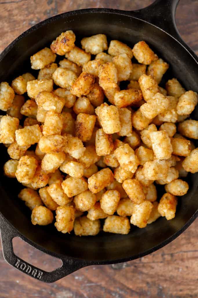 the baked tater tots now loaded into the cast iron ks