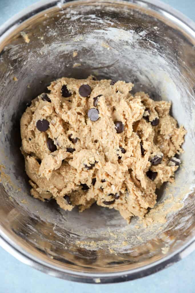 overhead photo of the combined cookie dough with dark chocolate morsels.