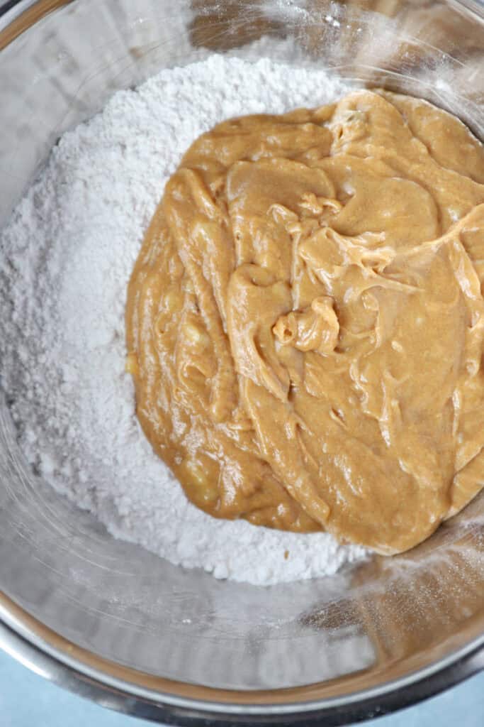 overhead photo of the dry cookie ingredients the wet and dry combined in a bowl.