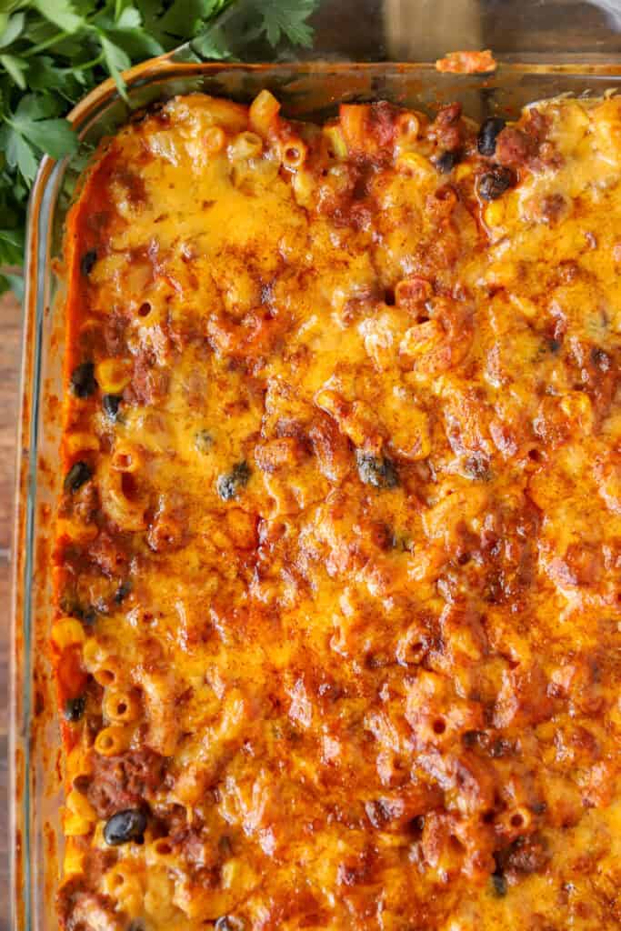 overhead photo of the baked taco pasta baked in the clear casserole dish.
