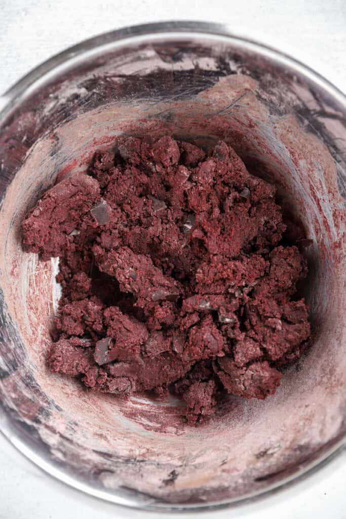 overhead photo of the combined cookie dough in a stainless steel bowl.
