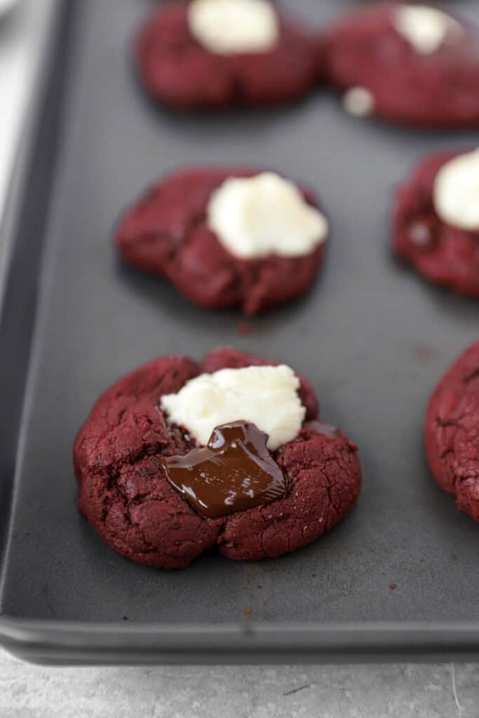 the baked red velvet cookies on the cookie sheet.