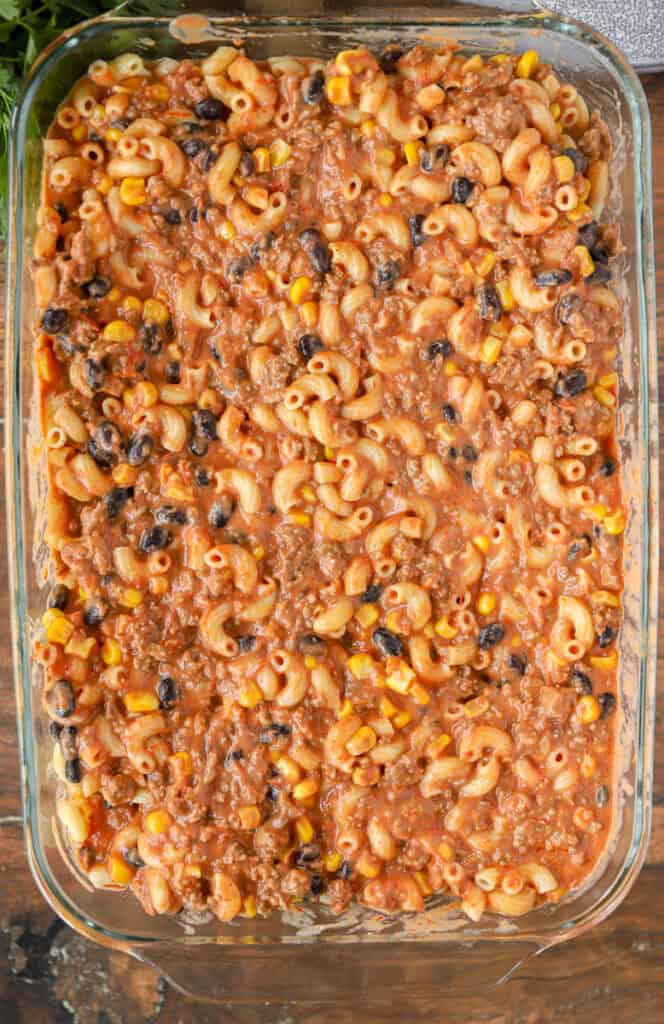 overhead photo of the taco pasta bake in the clear 9 x 13 casserole dish.