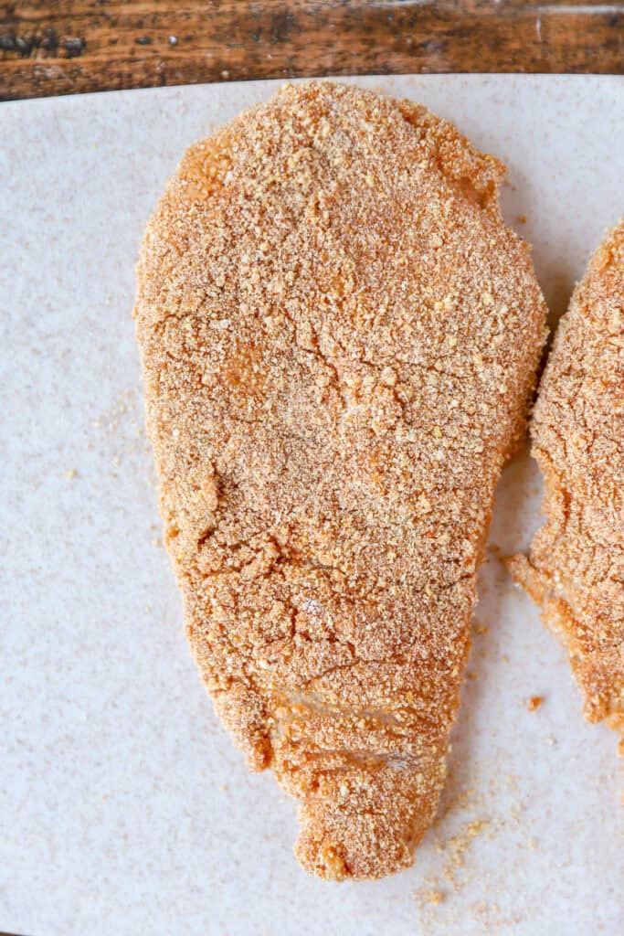 overhead photo of the raw chicken coated in the spicy breading.