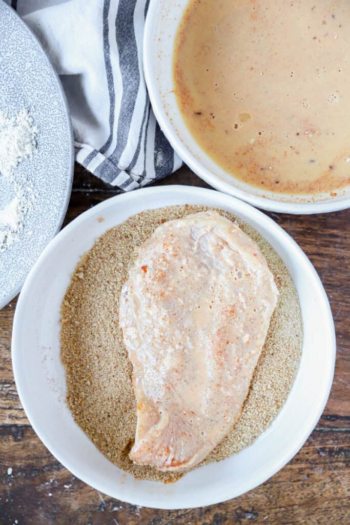 overhead photo of the raw chicken in the breading.