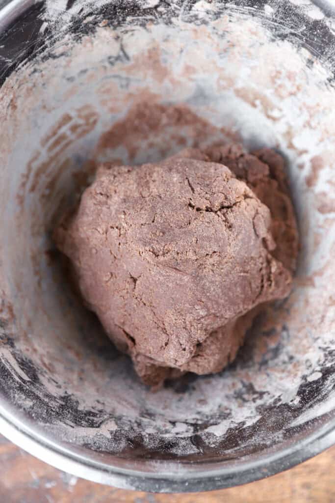 the cookie dough formed in a stainless steel bowl.