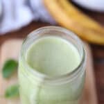 banana spinach smoothie in a mason jar glass